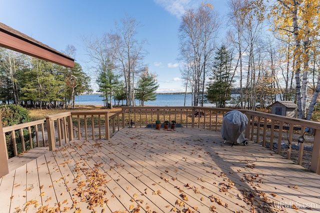 deck with a water view and grilling area