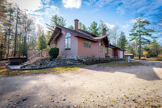 view of home's exterior featuring a hot tub