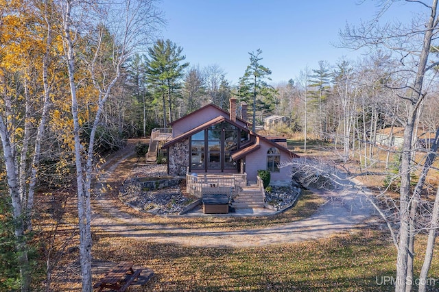 rear view of property featuring a deck