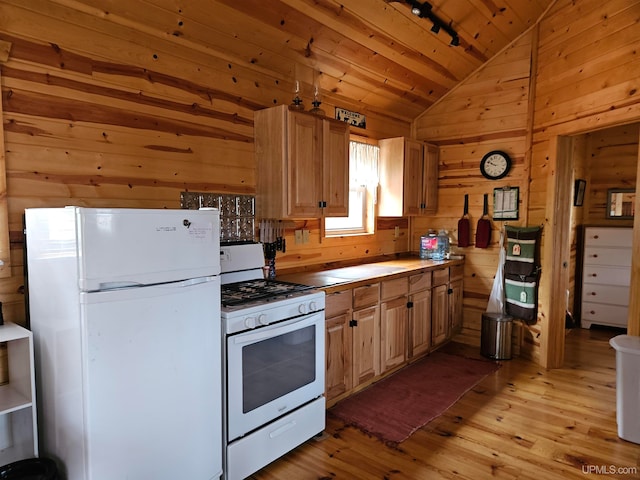 kitchen featuring lofted ceiling, white appliances, light wood-type flooring, and wood walls