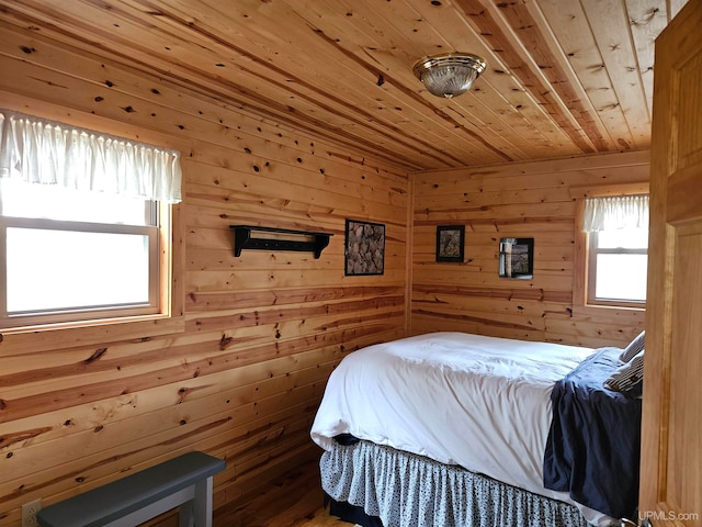 bedroom with wood walls and wooden ceiling