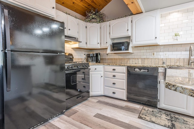 kitchen featuring lofted ceiling, light wood-type flooring, black appliances, white cabinets, and tasteful backsplash