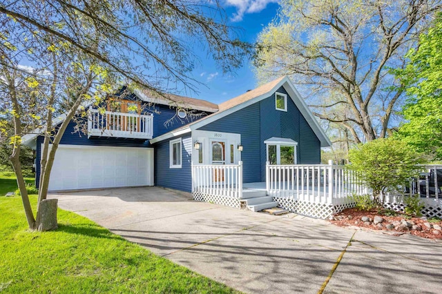 view of front of house with a front yard, a garage, and a deck