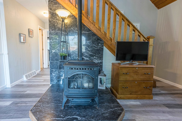 interior space featuring hardwood / wood-style flooring and a wood stove