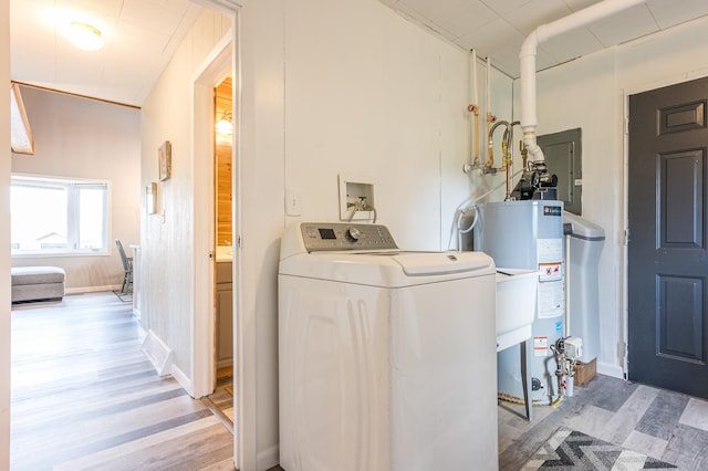 laundry room featuring washer / dryer, gas water heater, and hardwood / wood-style floors