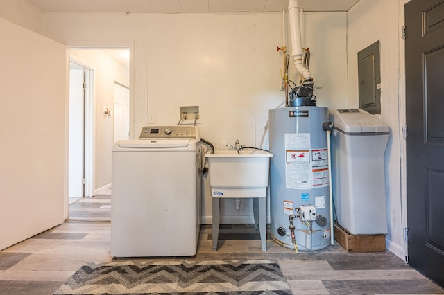 laundry area featuring washer / dryer, sink, light hardwood / wood-style floors, and gas water heater