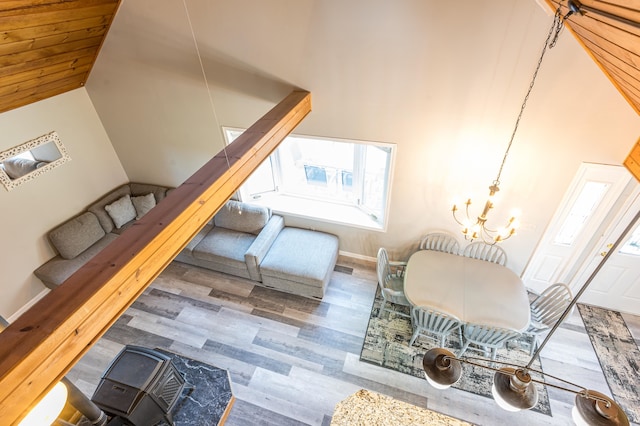 interior space featuring high vaulted ceiling, dark wood-type flooring, and an inviting chandelier