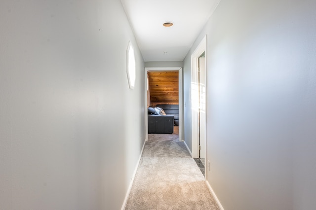 hallway featuring light colored carpet