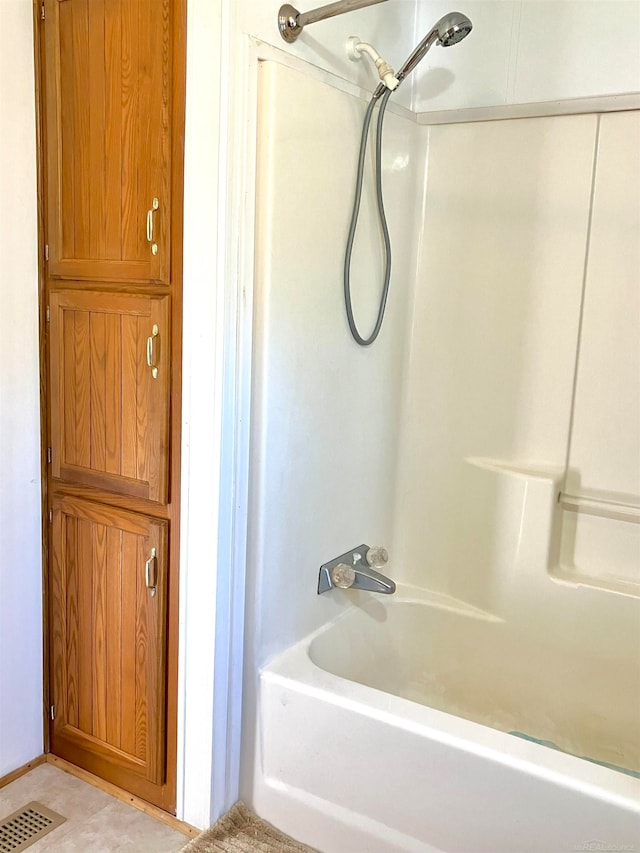 bathroom with shower / bath combination and tile floors