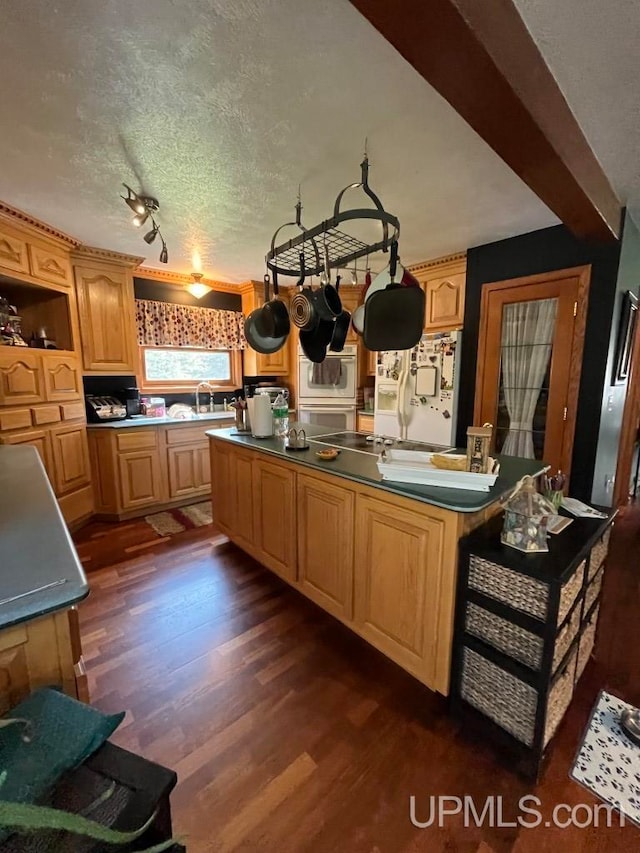 kitchen with a textured ceiling, dark hardwood / wood-style floors, white refrigerator with ice dispenser, and wall oven