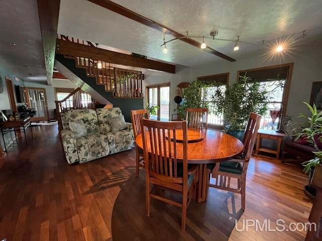 dining space with a textured ceiling and hardwood / wood-style flooring