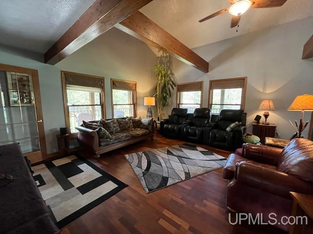 living room with a healthy amount of sunlight, vaulted ceiling with beams, ceiling fan, and hardwood / wood-style floors