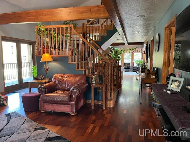 living room featuring beamed ceiling and wood-type flooring