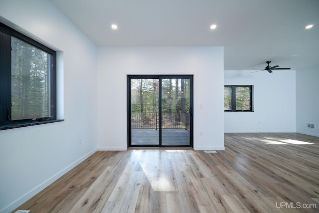 unfurnished room with light hardwood / wood-style flooring and ceiling fan