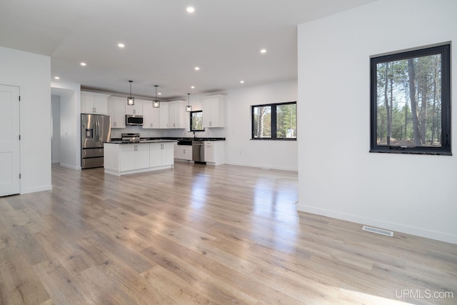 unfurnished living room featuring light wood-type flooring