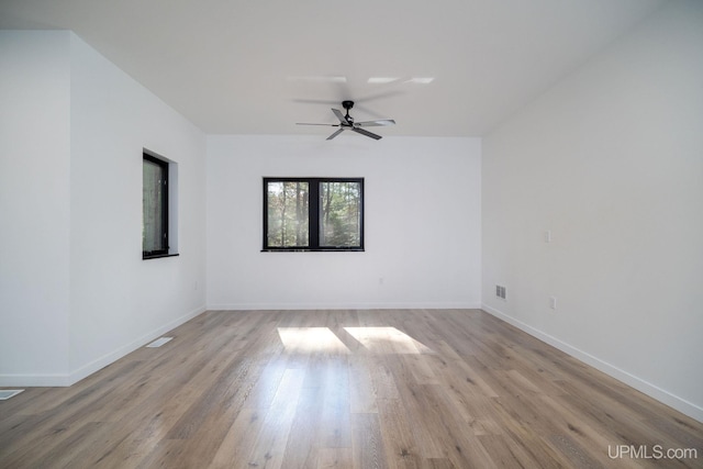 spare room featuring ceiling fan and light hardwood / wood-style floors