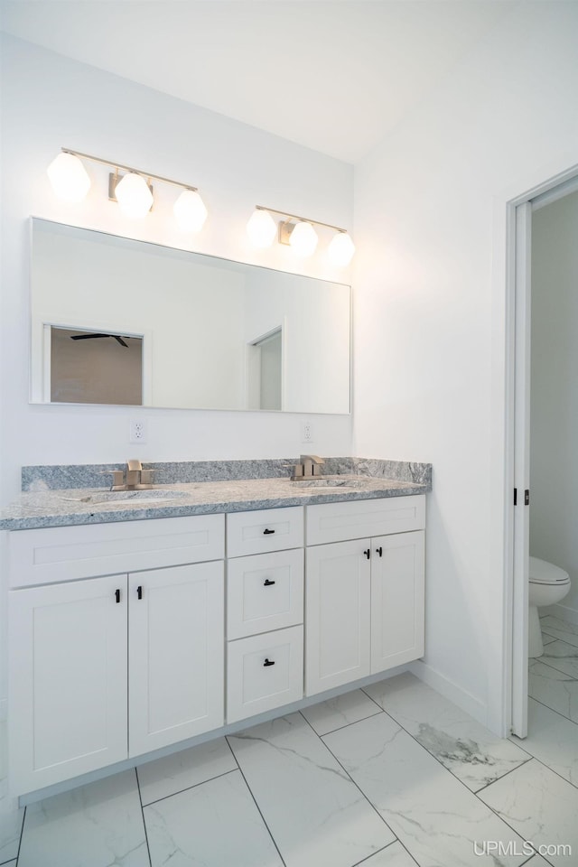 bathroom with vanity and toilet