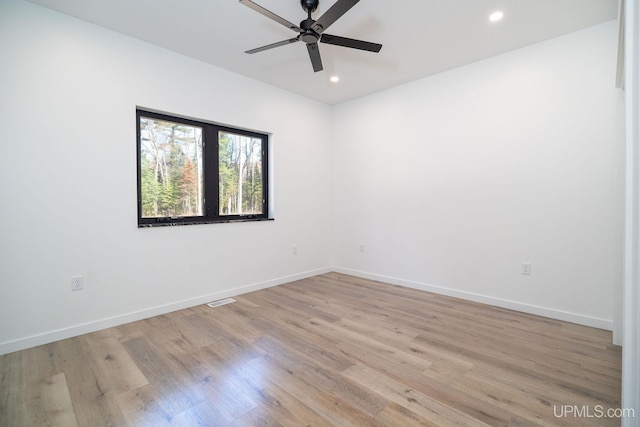 spare room featuring ceiling fan and light hardwood / wood-style floors