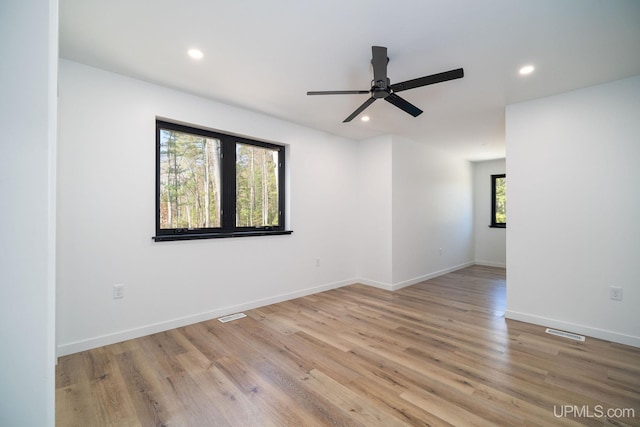 spare room with ceiling fan and light hardwood / wood-style flooring