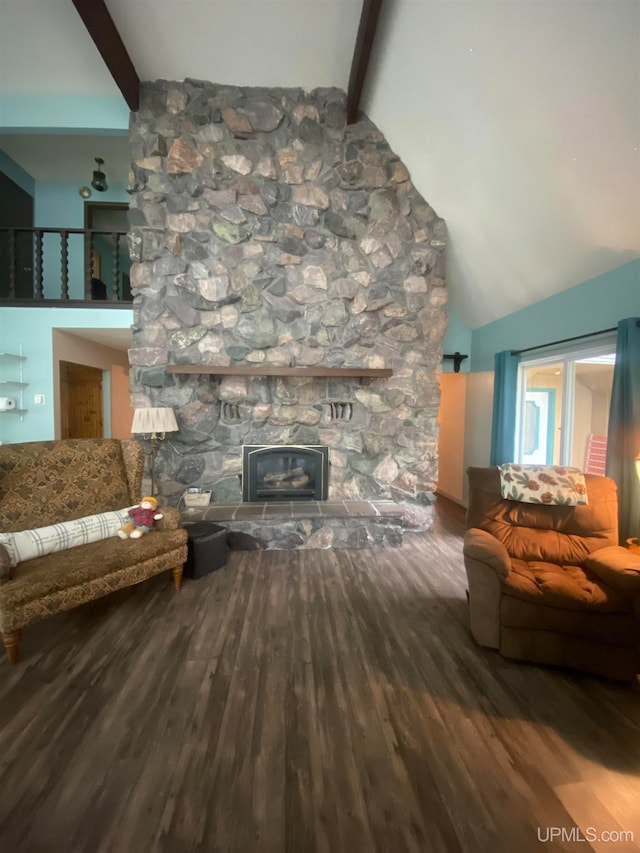 living room with hardwood / wood-style floors, a stone fireplace, high vaulted ceiling, and beamed ceiling