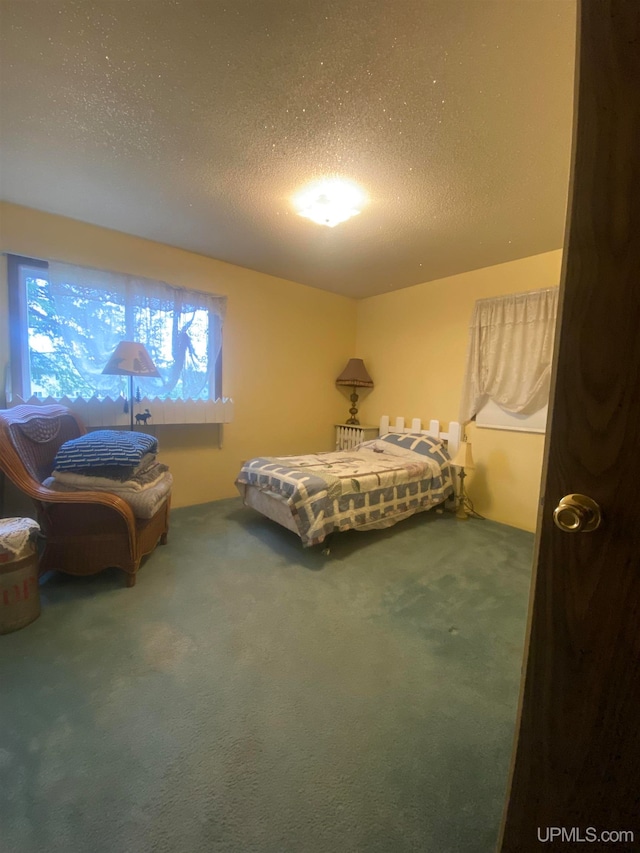 carpeted bedroom with a textured ceiling