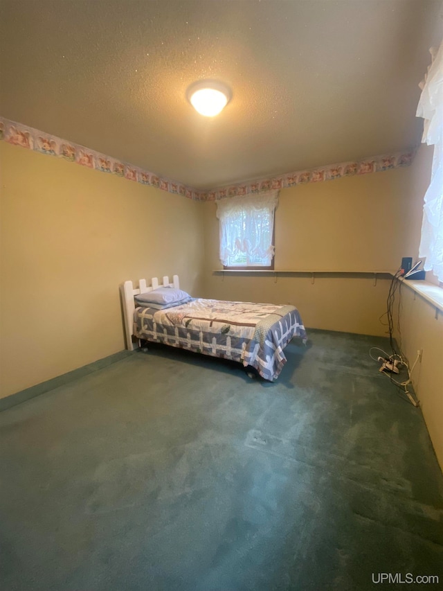 unfurnished bedroom featuring carpet floors and a textured ceiling