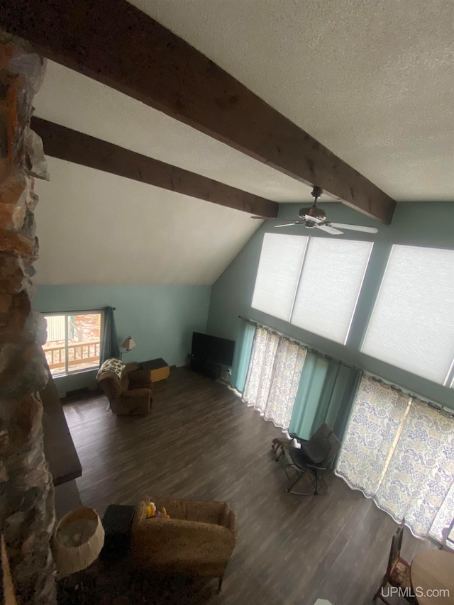 additional living space featuring lofted ceiling with beams, ceiling fan, dark hardwood / wood-style floors, and a textured ceiling