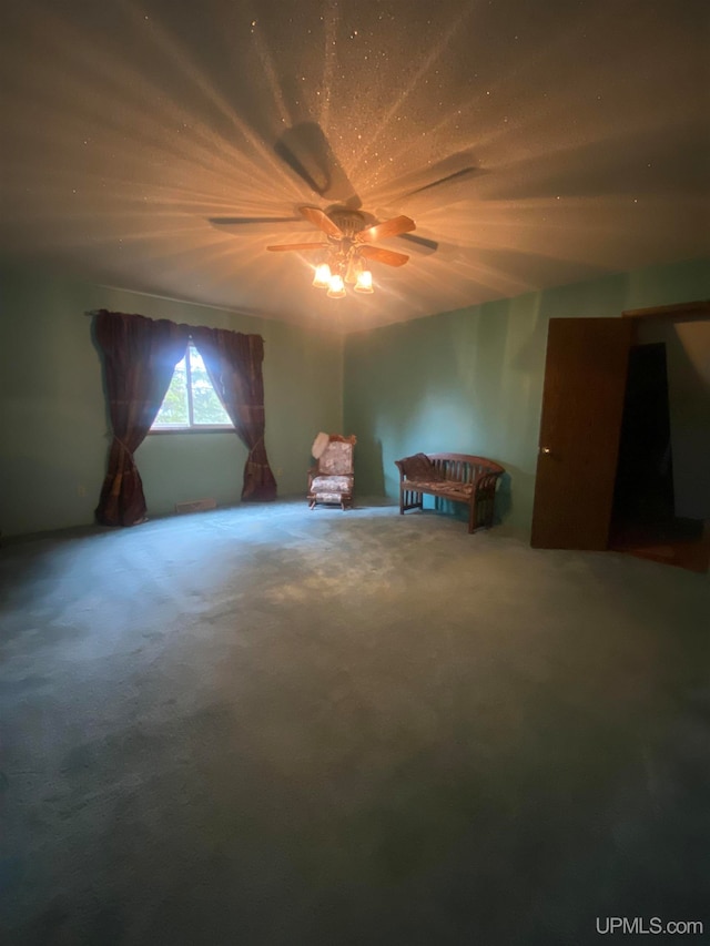 unfurnished bedroom with ceiling fan and carpet