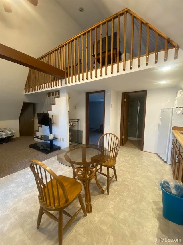 dining area featuring vaulted ceiling and ceiling fan