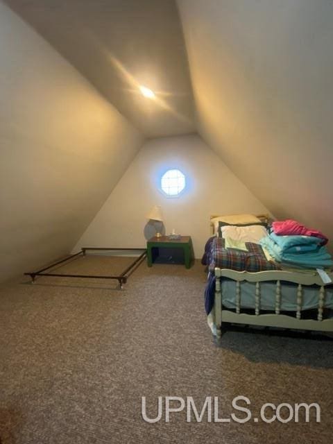 carpeted bedroom with vaulted ceiling