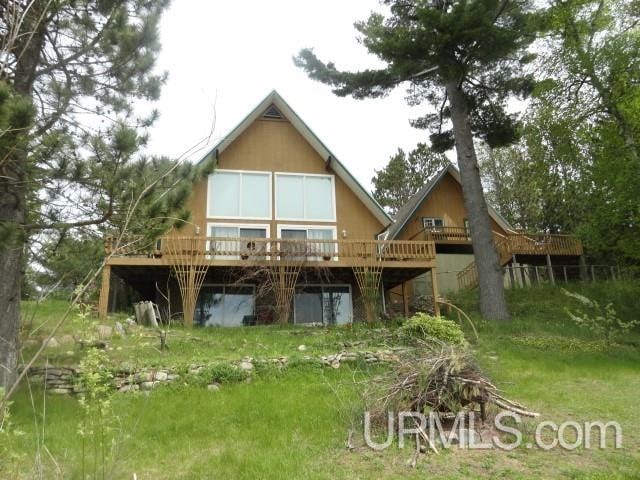 back of house with a wooden deck