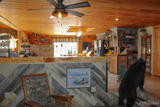 living room featuring hardwood / wood-style flooring, ceiling fan, and wood ceiling