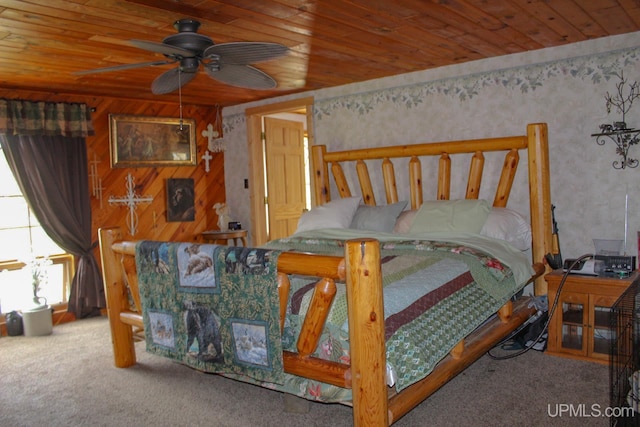 bedroom with carpet floors, wood walls, ceiling fan, and wood ceiling