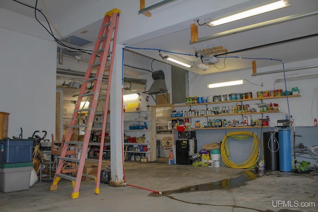 garage with a workshop area and a garage door opener