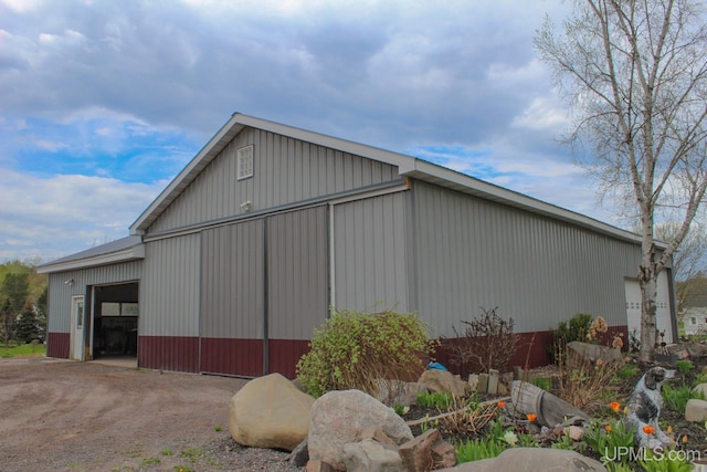 view of side of home featuring an outbuilding