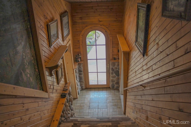 entryway with wood walls