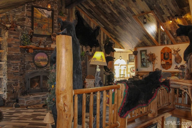 unfurnished living room with a stone fireplace, wood-type flooring, high vaulted ceiling, and wooden ceiling