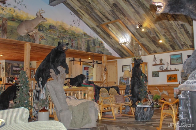 misc room featuring a barn door, hardwood / wood-style flooring, vaulted ceiling, and wood walls