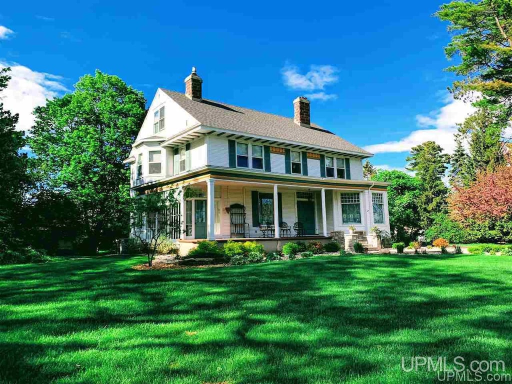 1204 Lake Shore Dr, Gladstone, MI 49837 - view of front of house with a front yard and a porch