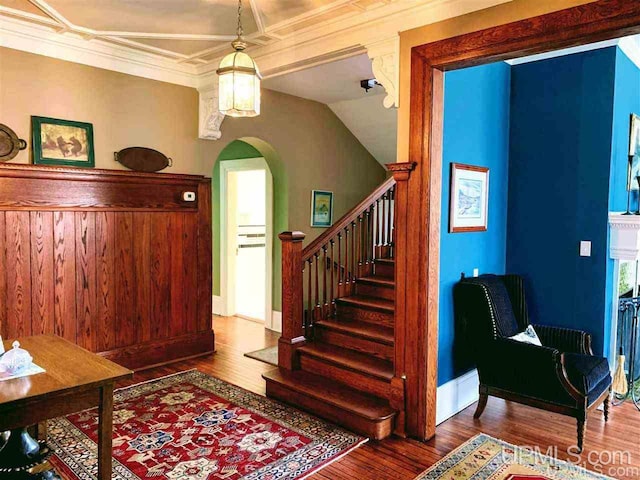 interior space with ornamental molding and dark hardwood / wood-style floors