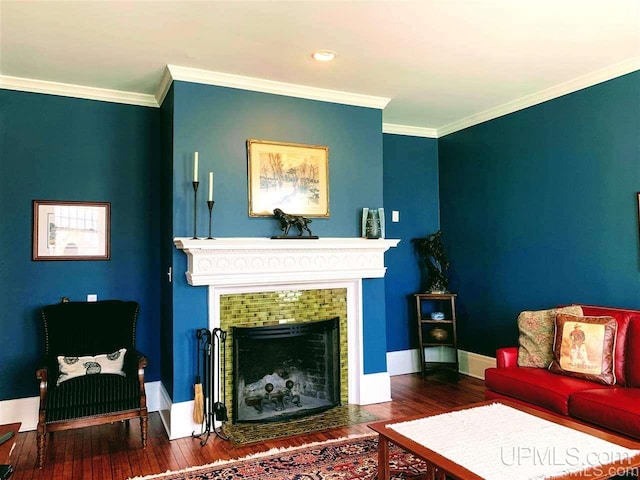 living room with dark hardwood / wood-style flooring and ornamental molding