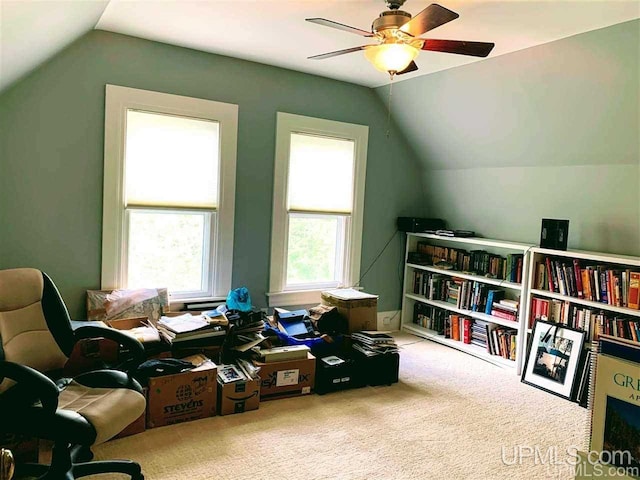 office space featuring carpet floors, ceiling fan, and vaulted ceiling