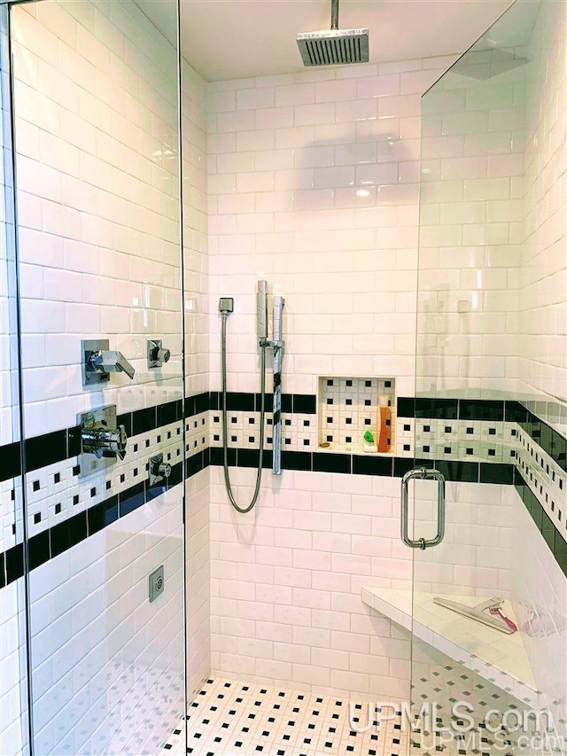 bathroom featuring a shower with door