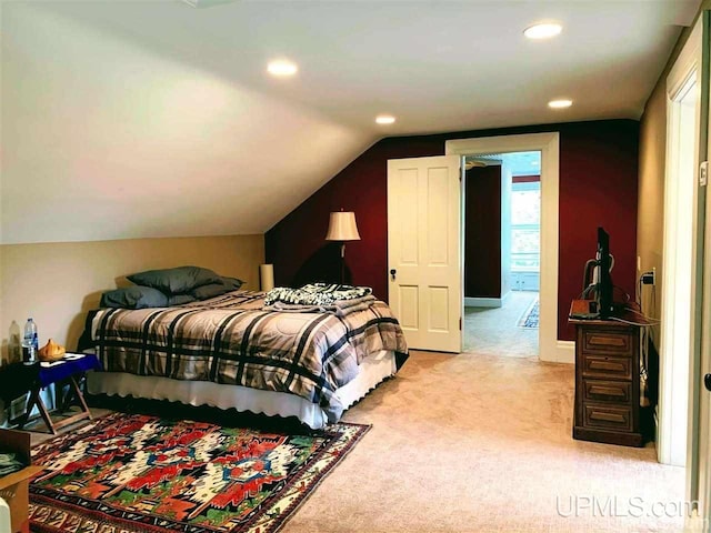 bedroom featuring carpet floors and vaulted ceiling