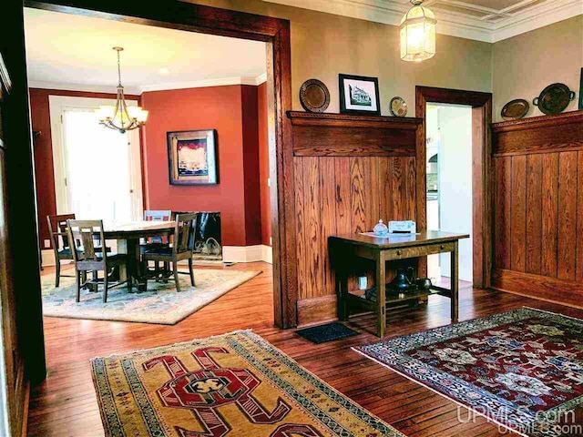 dining room with a chandelier, dark hardwood / wood-style floors, and crown molding