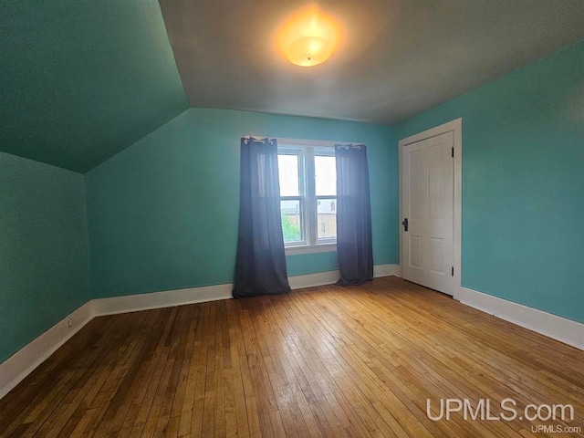 bonus room featuring hardwood / wood-style floors and vaulted ceiling