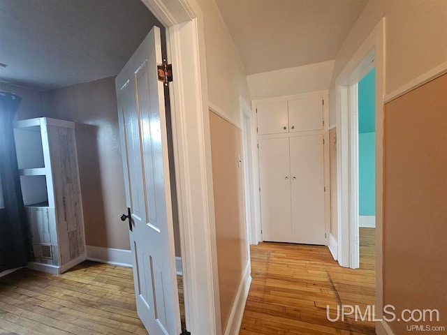 corridor with light hardwood / wood-style floors