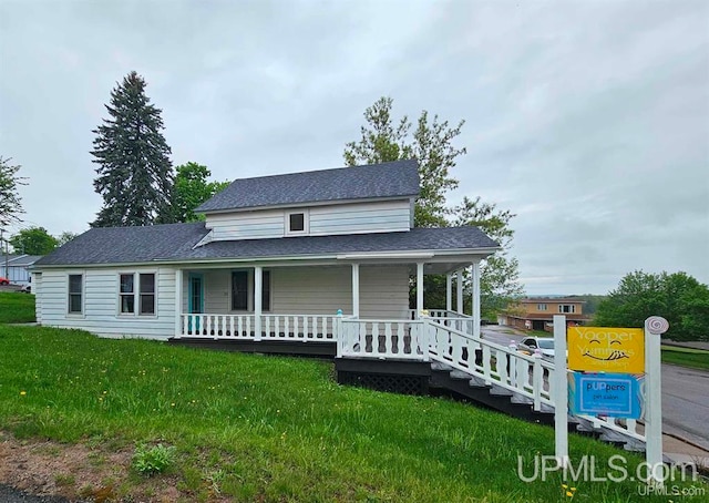 farmhouse featuring a porch and a front lawn