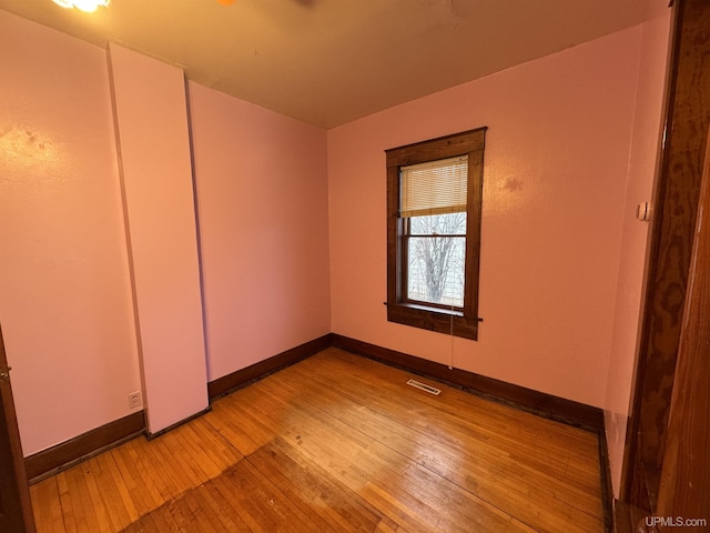 unfurnished bedroom with light hardwood / wood-style flooring and a closet