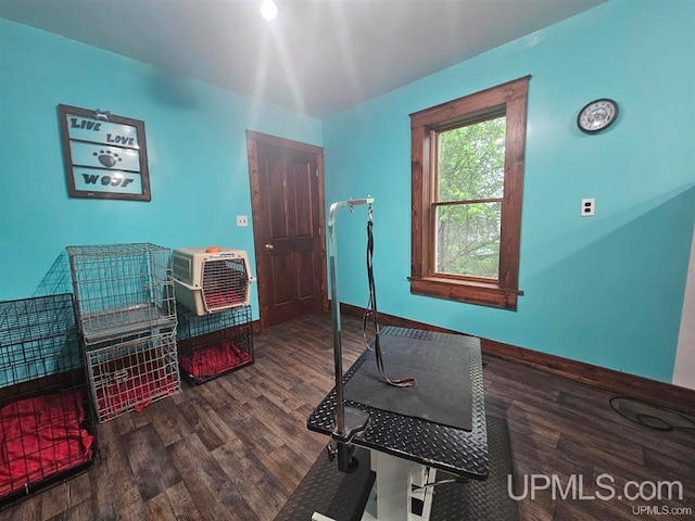 exercise area featuring wood-type flooring and a wall unit AC